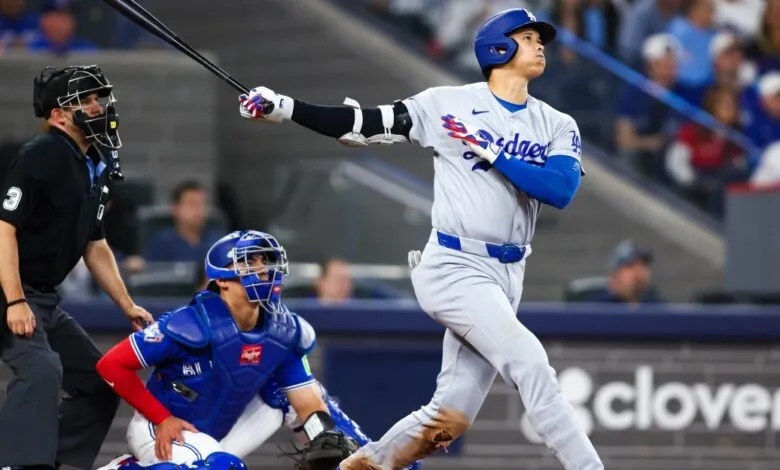 Dodgers batter swings at pitch during baseball game.