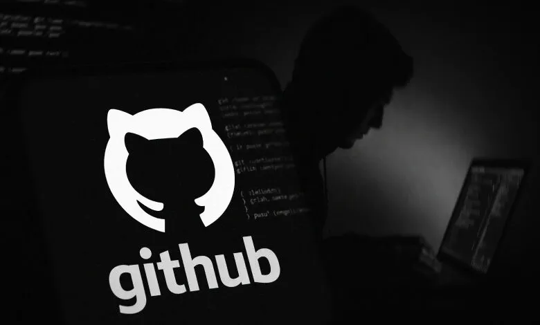 GitHub logo on phone screen with hacker silhouette in background.