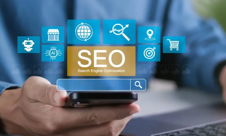 Person holding phone with SEO icons: robot, store, globe, chart, location, target, cart.