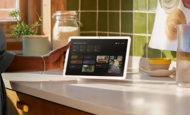 Google Nest Hub Max on kitchen counter, controlled by a person.