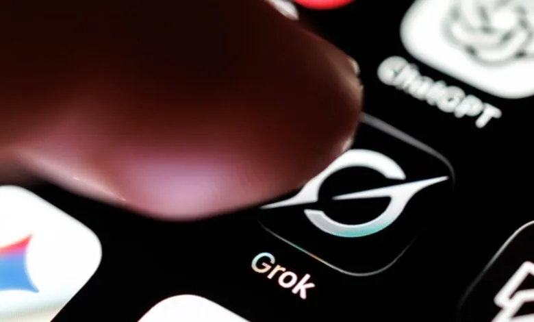 Finger taps Grok app icon on a smartphone screen.