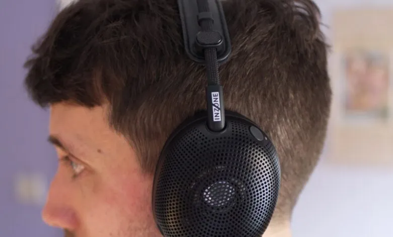 Close-up of black Inzone headphones on a person's head.