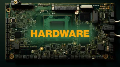 Close-up of a complex green circuit board with the word 'HARDWARE' in orange text.