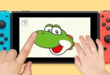 Nintendo Switch with Yoshi drawing game being played by child's hands.