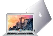 Silver MacBook Air laptop with mountain landscape wallpaper on screen.
