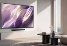 Modern living room with large TV displaying abstract art and minimalist decor.