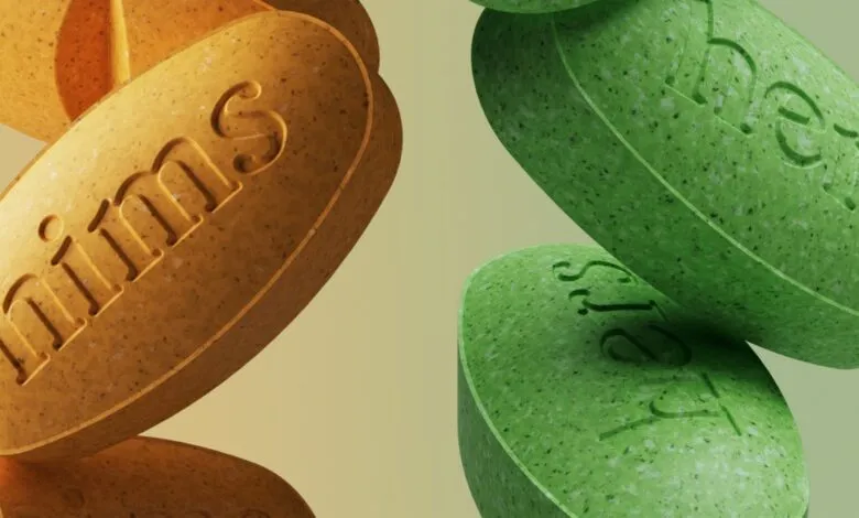 Close-up of orange 'hims' and green 'hers' pills.