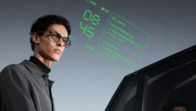 Man wearing smart glasses displaying calendar and time information.