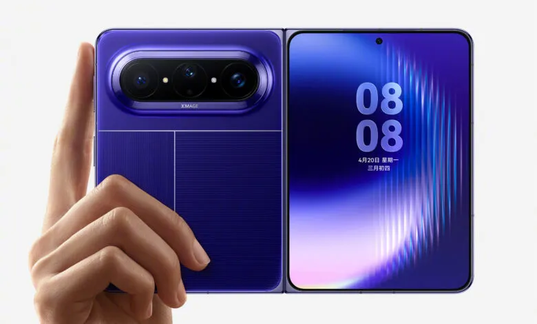 Hand holding open, purple foldable Huawei Pura X Max smartphone.