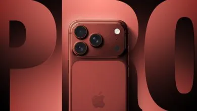 Deep red iPhone Pro with three cameras and Apple logo on back.