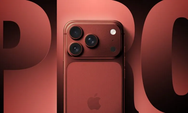 Deep red iPhone Pro with three cameras and Apple logo.