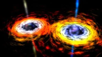 Two swirling black holes with colorful accretion disks and bright jets.