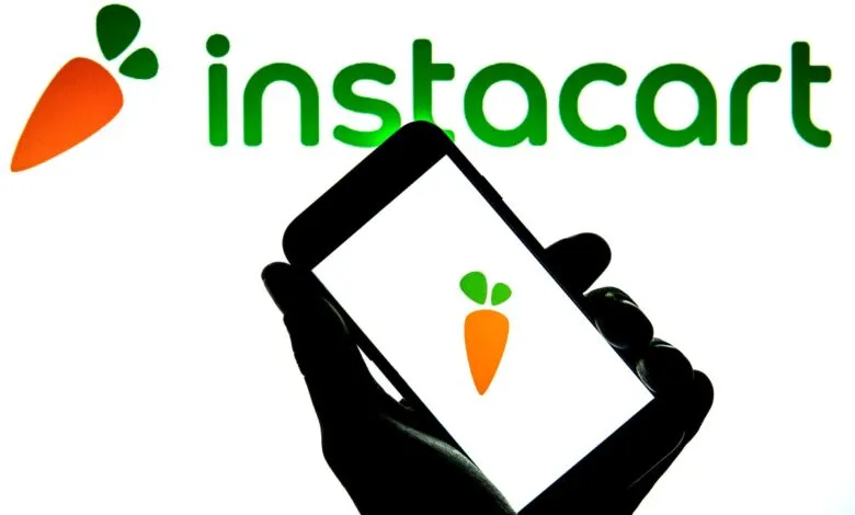 Instacart app on phone with logo, showing grocery delivery service.
