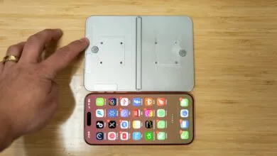 Foldable phone prototype next to iPhone with app icons visible.