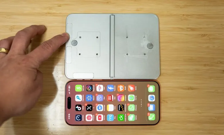 Foldable phone prototype next to iPhone with app icons visible.