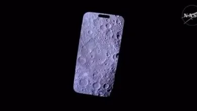 iPhone screen displays detailed lunar surface with craters, NASA logo in corner.