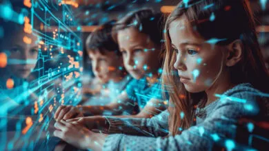 Four children looking intently at a screen displaying glowing digital patterns.