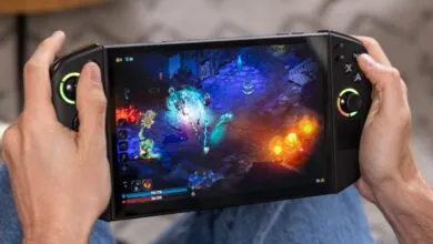Hands holding a Lenovo Legion Go playing a colorful action RPG.