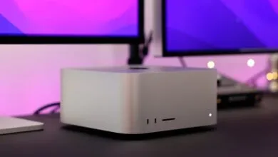 Close-up of a Mac Studio desktop computer with dual displays.