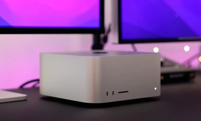 Close-up of a Mac Studio desktop computer with dual displays.