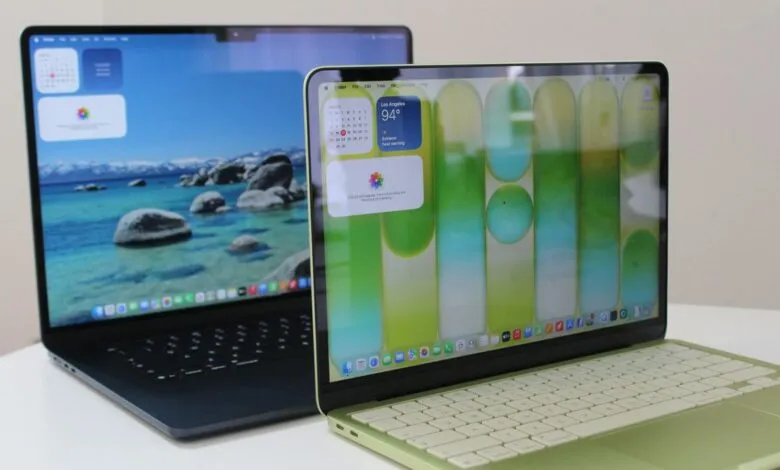 Two Apple MacBook Air laptops, one blue and one green, on a white table.
