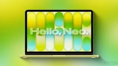 Citrus-colored laptop displays 'Hello, Neo.' against a vibrant, gradient background.