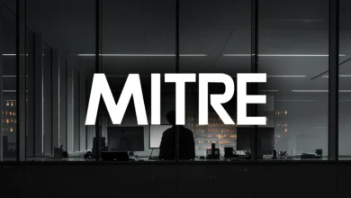 MITRE logo over silhouette of person at desk in modern office.