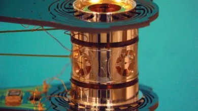 Close-up of a cylindrical metallic device with intricate wiring and circuit board elements.