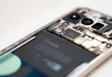 Close-up of a Google Pixel phone with its back removed, exposing internal components.