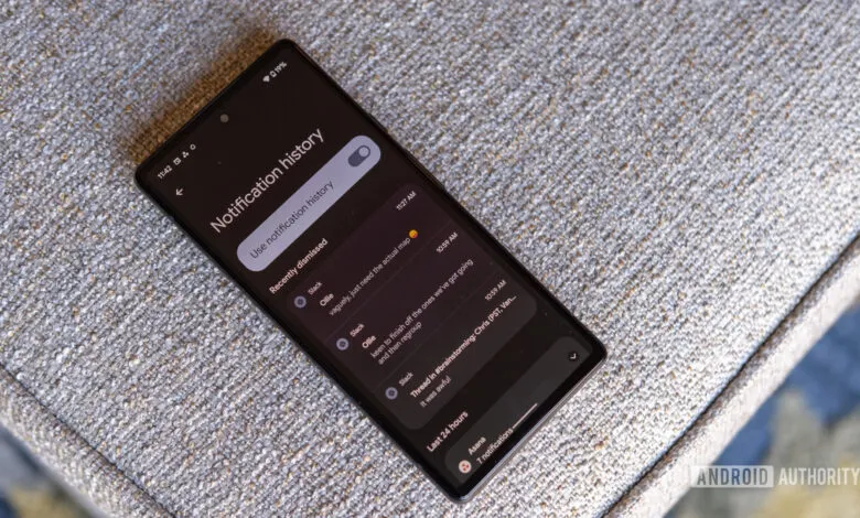 Pixel phone displaying notification history on a textured surface.