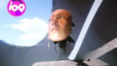 Floating robotic head with human-like face against a sky backdrop.