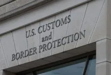 U.S. Customs and Border Protection sign on a stone building.