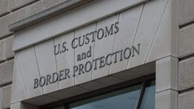 U.S. Customs and Border Protection sign on a stone building.