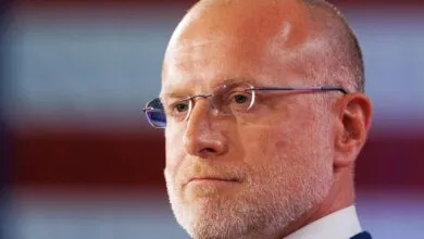 Close-up of Brendan Carr with glasses against blurred background.