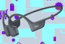 Gray Shokz OpenRun Pro bone conduction headphones on a colorful background.