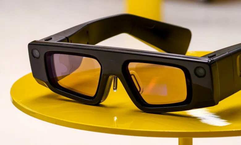 Snapchat Spectacles on a yellow table, showcasing the camera and lens.