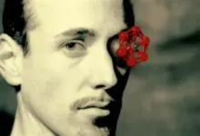 Valve guy with red valve over eye, sepia-toned image.