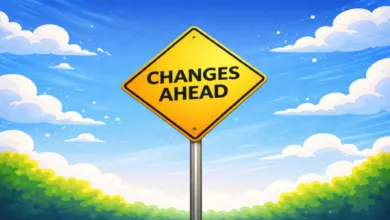 Yellow diamond 'Changes Ahead' sign against a blue sky with fluffy clouds.