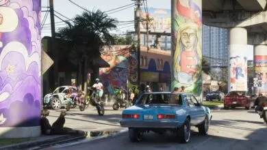 Street scene with colorful murals, cars, and people on motorcycles.