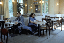 Interior of a cafe with people seated at tables, natural light.
