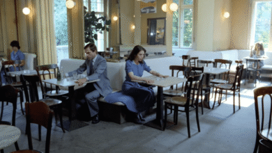 Interior of a cafe with people seated at tables, natural light.