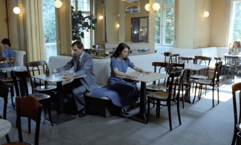 Interior of a cafe with people seated at tables, natural light.