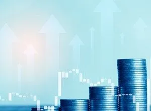 Stacks of coins increasing in height, overlaid with upward-pointing arrows and a financial chart.