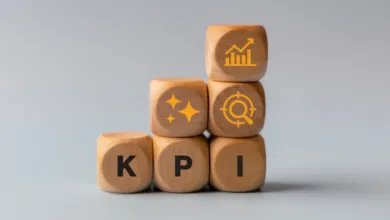 Wooden blocks stacked with KPI letters and performance icons.