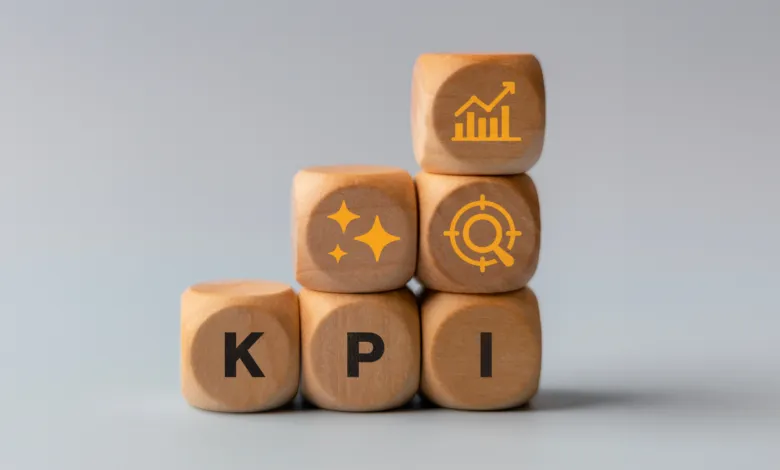 Wooden blocks stacked with KPI letters and performance icons.