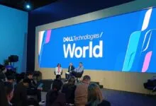 Dell Technologies World event with speakers on stage and audience.