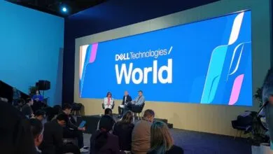 Dell Technologies World event with speakers on stage and audience.