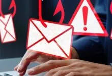 Hands typing on laptop with phishing email and warning icons overlaid.