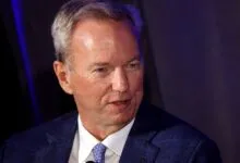Eric Schmidt, former Google CEO, in a blue suit.
