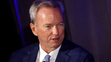 Eric Schmidt, former Google CEO, in a blue suit.